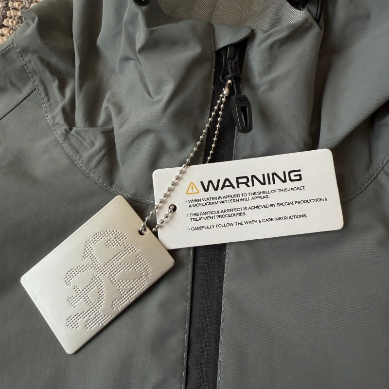 mertra - Monogram Shell Jacket (Grey) - Water Reactive Monogram Pattern Effect